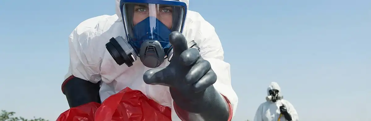 sewage clean up technician wearing protective gear handling biohazard materials in Oakland, CA