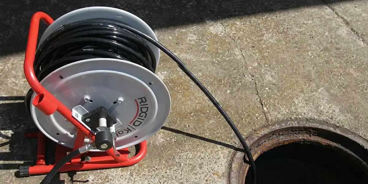 sewer rodding equipment prepared to clear clogged sewer lines in Oakland, CA